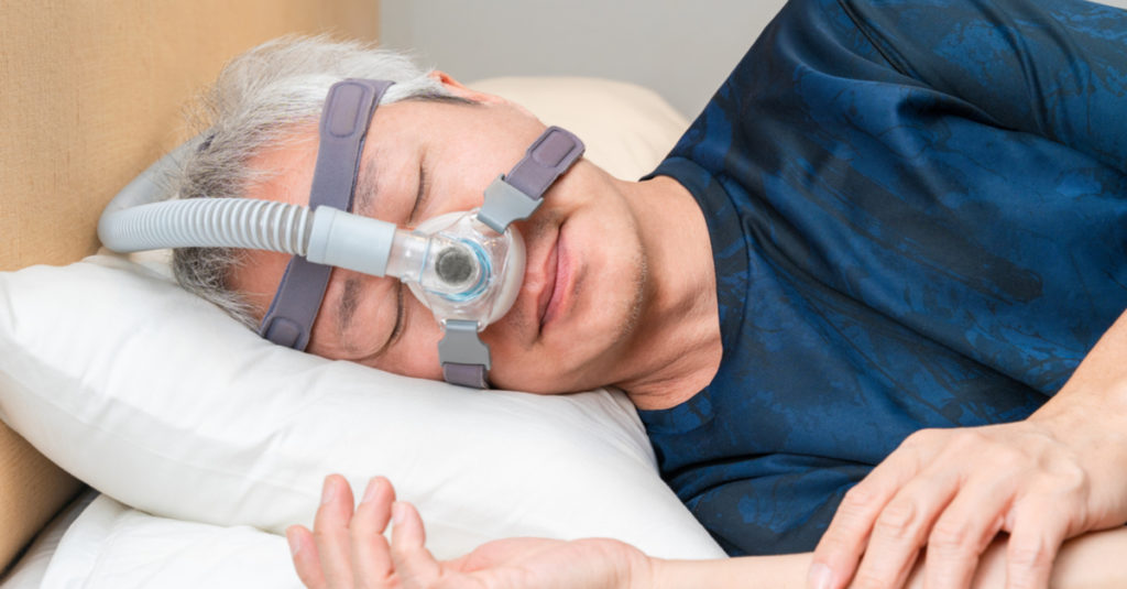 man sleeping with cpap and alternative oral appliances