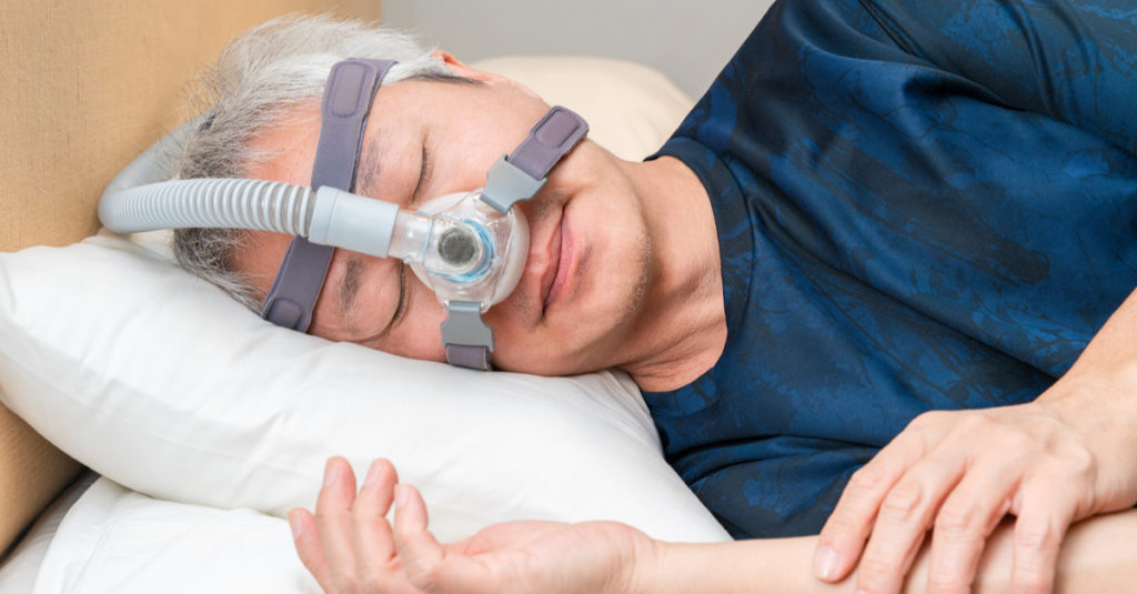 man wearing a CPAP - sleep apnea facts